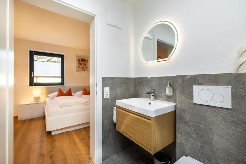 a bathroom with a sink and a mirror at S Apartment in Flachau