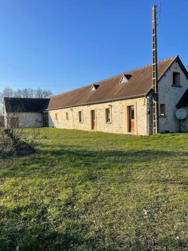 Maison Le Mans في Teloché: مبنى حجري قديم على أرض عشبية