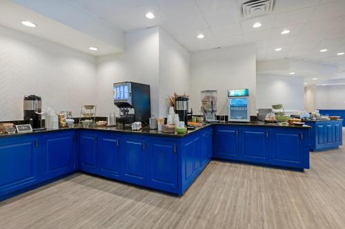 a large room with blue counters in a cafeteria at The Lux Hotel & Conference Center, an Ascend Collection Hotel in Waterloo