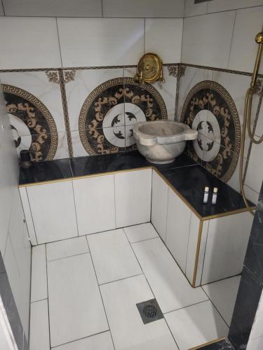 a bathroom with a bowl on a counter with plates at Angelina's Home and Spa Alexandroupolis in Alexandroupoli
