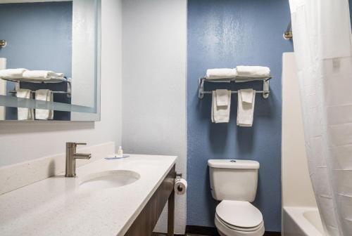 a bathroom with a white toilet and a sink at Quality Inn - On The Lake Clarksville-Boydton in Clarksville