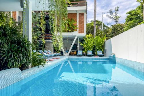 a swimming pool in front of a building at Viroth's Villa in Siem Reap