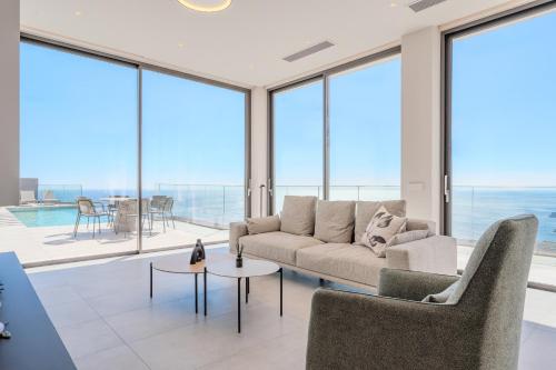 a living room with a couch and chairs at Dione Villa in Sellía
