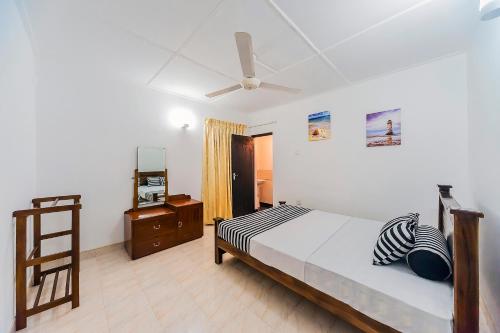 a bedroom with a bed and a ceiling fan at Cloud Inn Kandy Homestay - Near Temple of Tooth in Kandy