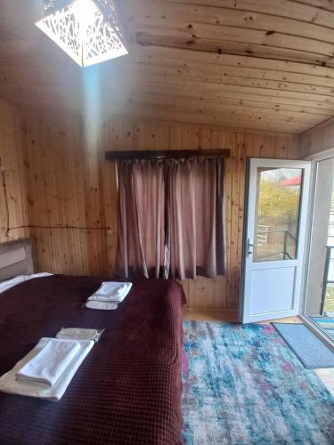 a bedroom with a large bed with a window at Sesili's apartment in Stepantsminda