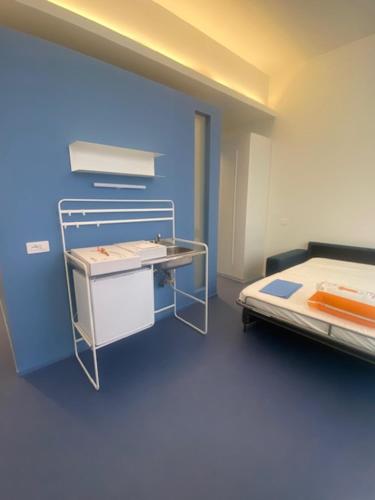 a blue room with a bed and a table at Mediterranea in Arenzano