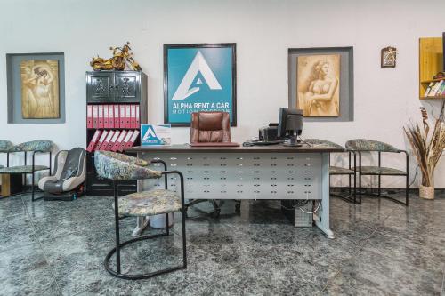an office with a desk and chairs in a room at Alpha Studios in Arkasa