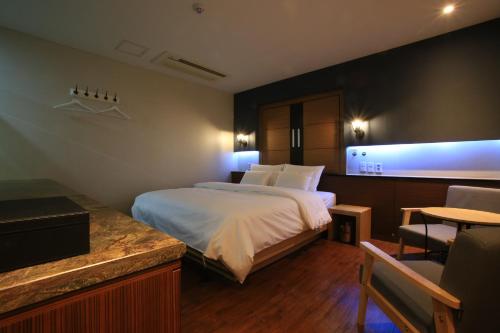 a hotel room with a bed and a table at The Ace Hotel in Seoul