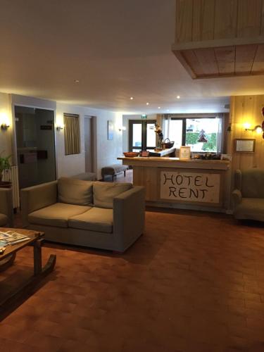 a living room with a couch and a coffee table at Hôtel Rent in Megève