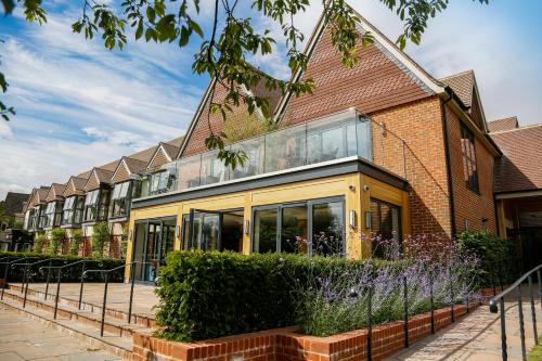 a brick building with glass windows on the side of it at The Swan, Streatley, Berkshire in Streatley