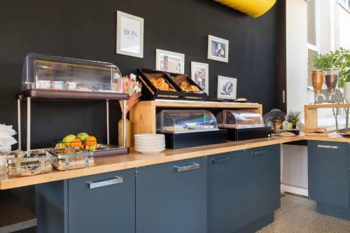 a kitchen with a counter with food on it at Comfort Aparthotel Antibes Le Maestria in Antibes