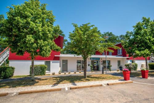 a building with trees in front of it at Comfort Aparthotel Nantes La Beaujoire in Nantes
