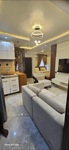 a large living room with couches and a kitchen at Ladi's Place 2, Anthony, Ikeja in Lagos