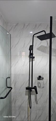 a shower with a glass door in a room at Ladi's Place 2, Anthony, Ikeja in Lagos