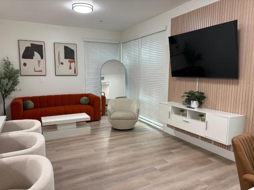 a living room with a red couch and a tv at Modern Crypto Luxury Living in Los Angeles