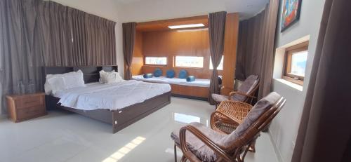 Ένα ή περισσότερα κρεβάτια σε δωμάτιο στο Aavasan home stay