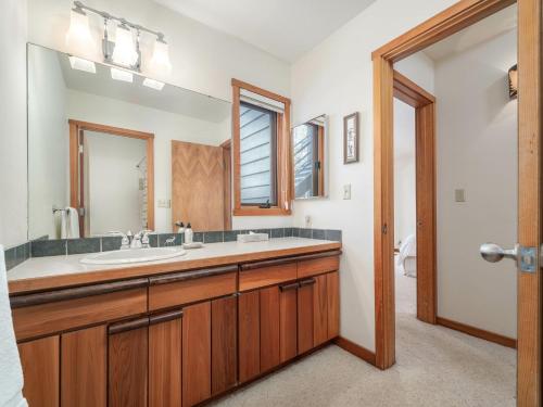 a bathroom with a sink and a mirror at RMR: Wheatgrass 2212 Condo in The AspensWilsonWY in Wilson