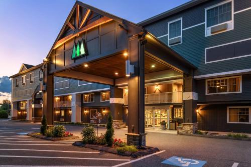 a large building with a sign on the side of it at Maine Evergreen Hotel, an Ascend Collection Hotel in Augusta