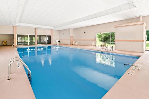 a large pool with blue water in a building at Quality Inn Dayton Airport in Englewood