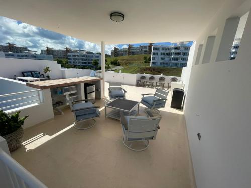 a patio with chairs and a table on a balcony at Pearl of the East in Ceiba with Ocean View and Private Rooftop in Santa Maria