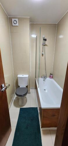a bathroom with a toilet and a sink and a tub at Home on Piccadilly Line in London