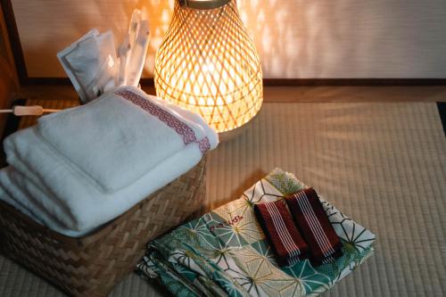 a room with a chair and a pillow and a lamp at ヴィラこんぴら Villa Konpira in Kotohira