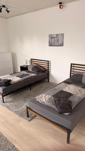 two beds sitting in a room with at Fewo Monteurwohnung SAW in Salzwedel