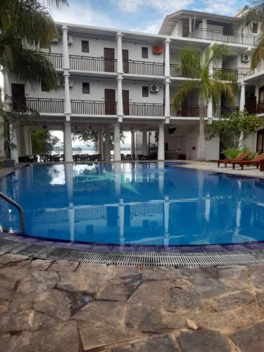 a large swimming pool in front of a building at Oga Reach Yala in Lukasgoda