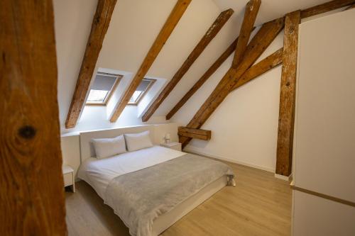 a bedroom with a bed in a room with wooden beams at Palatul Lugoj in Lugoj