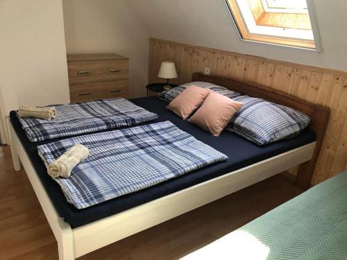 a bedroom with a bed with two pillows on it at PäRLAN APARTMAN in Balatonboglár