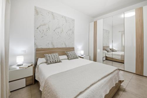 Ένα ή περισσότερα κρεβάτια σε δωμάτιο στο Figarolo apartment by Residence Moresca