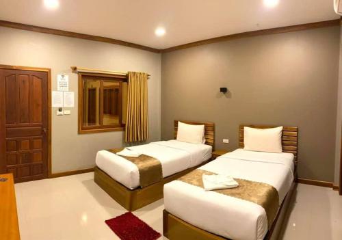 Llit o llits en una habitació de Champadiamon hotel
