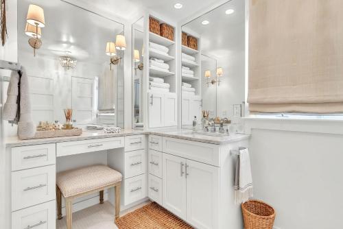 a white bathroom with a sink and a mirror at On the Beach in Santa Rosa Beach