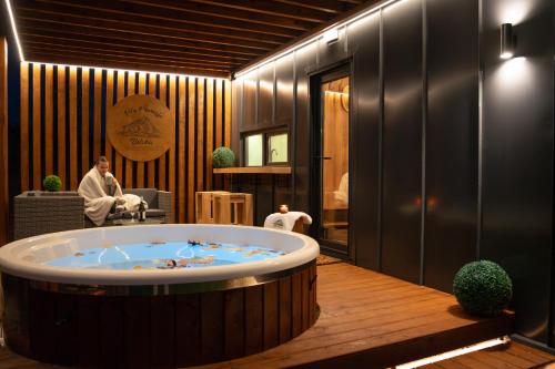 a jacuzzi tub in the middle of a room at Brvnara Vila Promaja in Kladovo