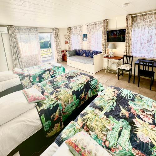 een hotelkamer met twee bedden en een bank bij Rooi Bij de Knoptoren B&B in Sint-Oedenrode