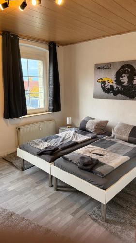a bedroom with two beds and a window at Fewo Monteurwohnung SAW II in Salzwedel