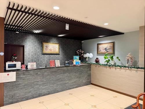 a restaurant with a counter and a microwave at Hotel Arashi Namba No002 in Osaka