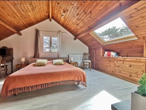 a bedroom with a bed and a large window at Charmant dupleix à La Baule, proche de la mer in La Baule