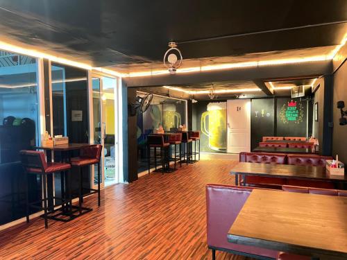 a bar with chairs and tables in a room at Lemon Tree Hostel Khaosan in Bangkok