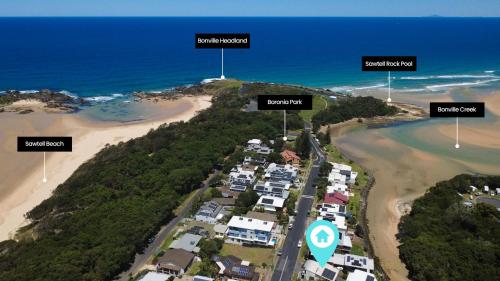 an aerial view of a beach with houses at Stunning Ocean-View Home, Walk to Village & Beach in Sawtell