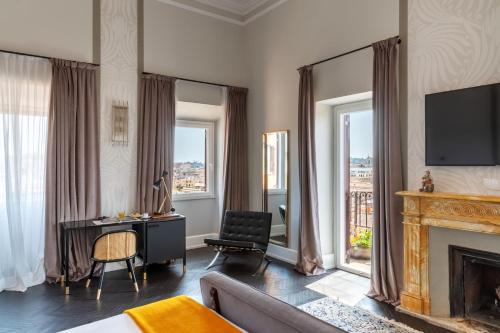 a living room with a fireplace and a television at Hotel Scalinata Di Spagna in Rome