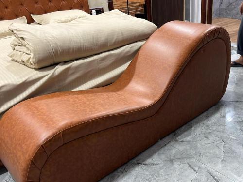 a brown leather foot board of a bed at Hotel O RG PALACE HOTEL in Bagru