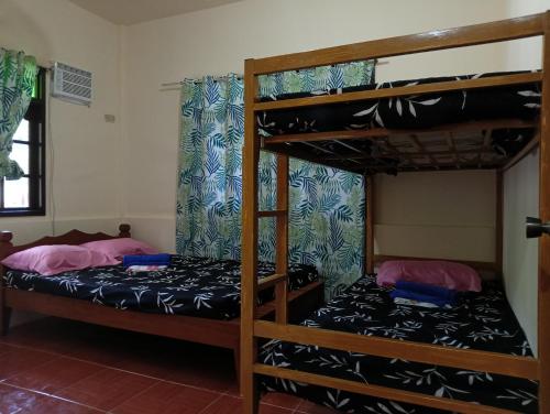 two bunk beds in a dorm room with at El Nido Cabugao Loudge in El Nido
