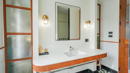a bathroom with a sink and a mirror at Sugar Marina Resort-LAGOON-Villas, Naiyang Beach in Nai Yang Beach