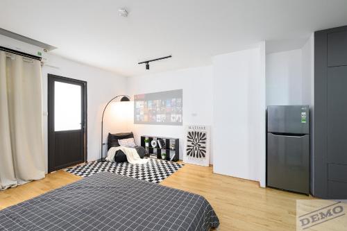 a white room with a bed and a refrigerator at Love Paradise Hotel Hà Nội in Hanoi