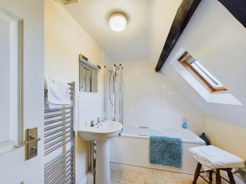 a bathroom with a sink and a bath tub at Sea Loft Penthouse - Whitby in Whitby