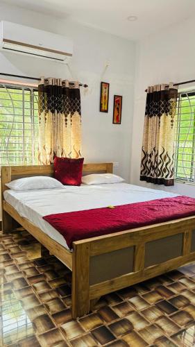 a bedroom with a large bed in a room at ALOamarALO - Homely Comfort with a Touch of Luxury at Shantiniketan in Shānti Niketan