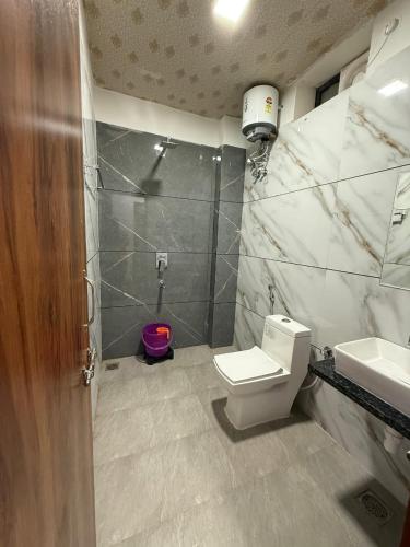a bathroom with a toilet and a sink at Braham Niwas Resort in Pushkar