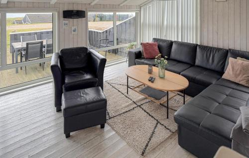 a living room with a couch and chairs and a table at Amazing Home In Ebeltoft With Sauna in Ebeltoft