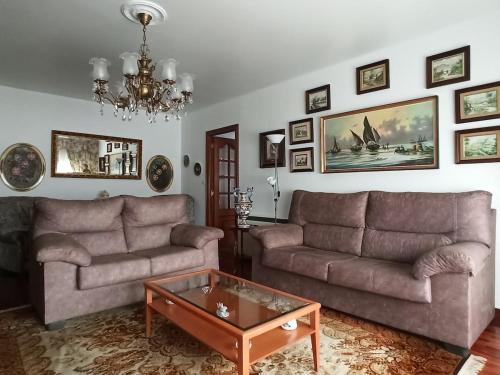 a living room with two couches and a coffee table at Piso Amplio y Céntrico en Mugardos in Mugardos